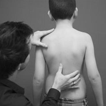 Chiropractor examining a child's spine at Vitality Chiropractic Perth